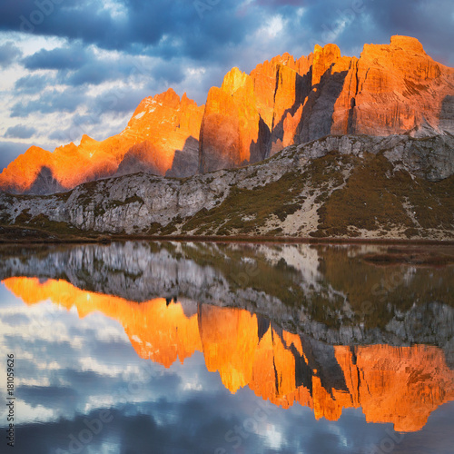 Obraz na płótnie Evening on Laghi dei Piani (Lakes Piano) with mountains in sunlit reflected in smooth surface lake water, Southern Tyrol, Dolomites, Tre Cime di Lavaredo National Park, Italy. Enrosadira. w salonie