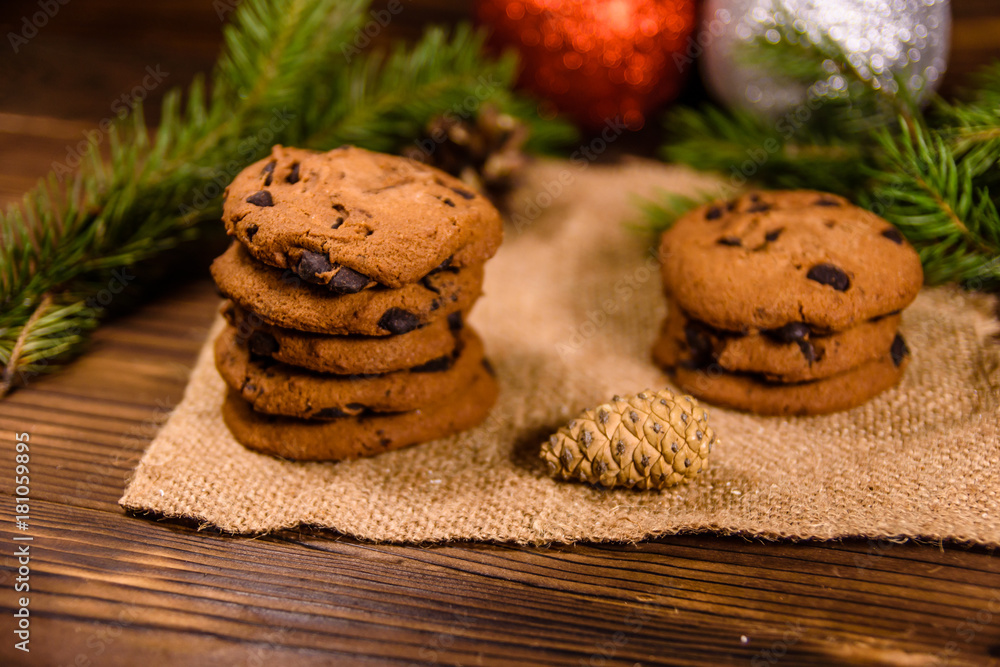 Chocolate chip cookies and christmas decorations on a wooden table Chocolate chip cookies and christmas decorations on a wooden table