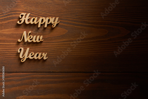 Happy New Year!/Happy New Year! - A phrase with wooden letters on a wooden backg