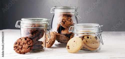 Cuadro en lienzo Chocolate cookies in a glass jar on white background.
