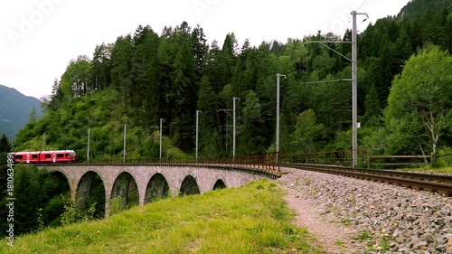 The train passes through the famous Landwasser viaduct in Switzerland.