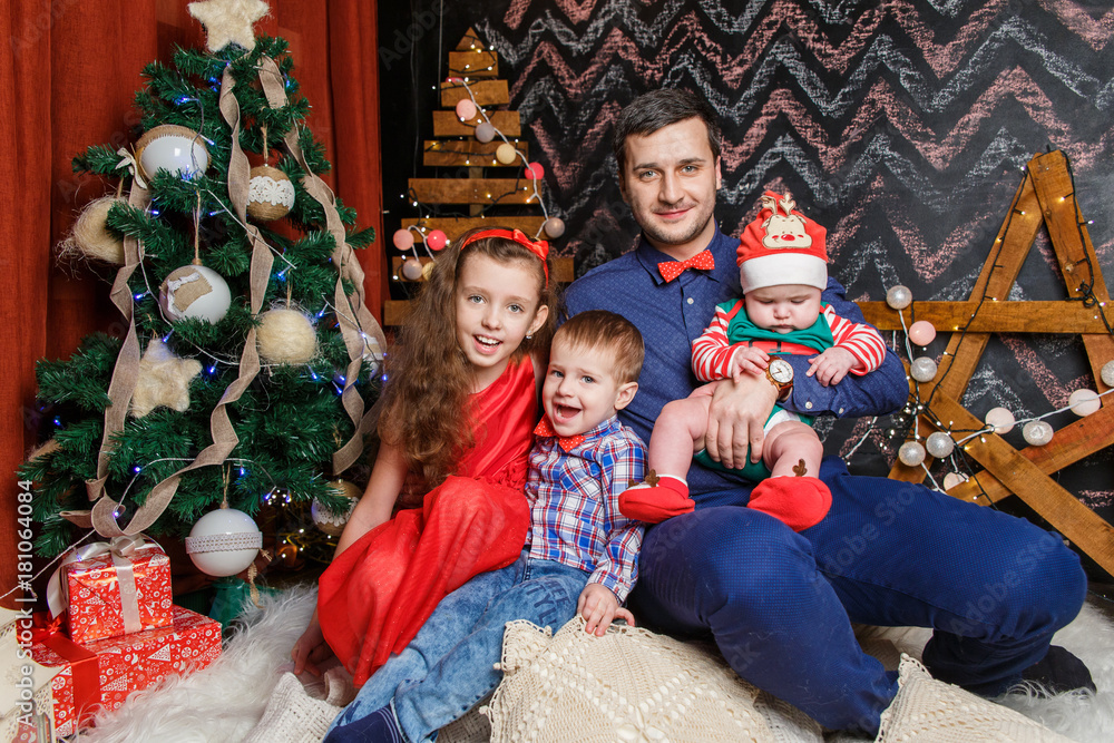 Father with kids in a Christmas photo session Father with kids in a Christmas photo session