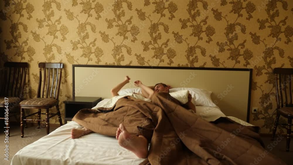 couple in bed making love. male and female legs top view, white linens