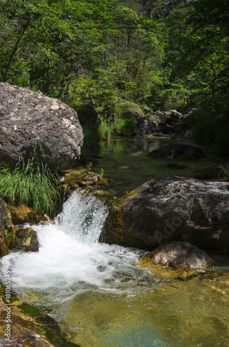 mountain river with a small waterfall