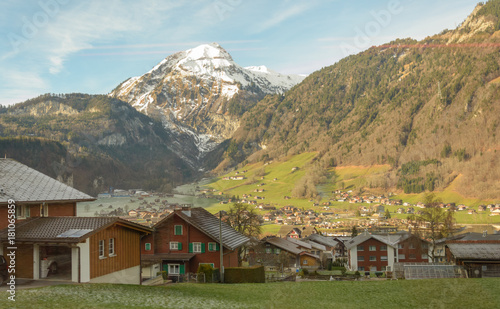 Snowy mountains and houses in Switzerland photo
