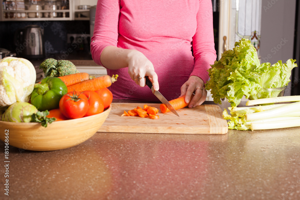 Pregnant woman is cooking Pregnant woman is cooking