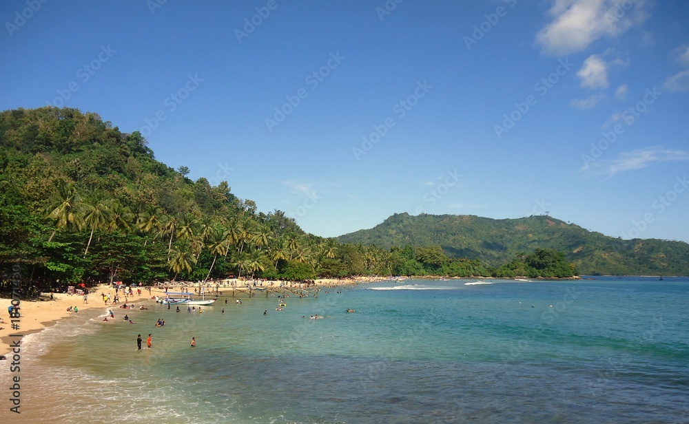 Beautiful beach with green hill on the background Beautiful beach with green hill on the background