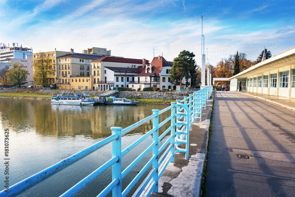 Bridge to spa island in Piestany, Vah river, riverbank, blue sky (Slovakia)