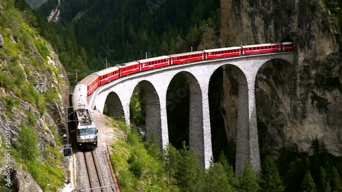 The train passes through the famous Landwasser viaduct in Switzerland. Top view.