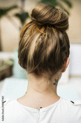 Rear view of woman with tattoo at her neck