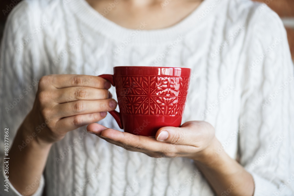 Closeup of woman holding hot drink cup