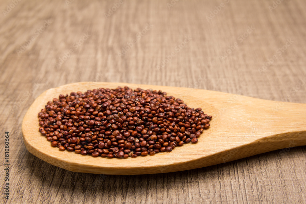 Red Quinoa seed. Grains in wooden spoon. Rustic. Red Quinoa seed. Grains in wooden spoon. Rustic.