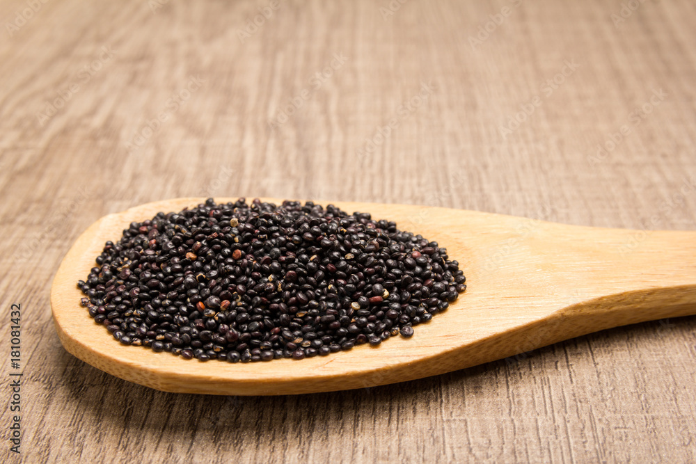 Black Quinoa seed. Grains in wooden spoon. Rustic. Black Quinoa seed. Grains in wooden spoon. Rustic.