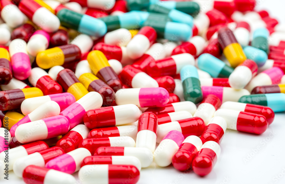 Selective focus on colorful of antibiotic capsules pills on blur background with copy space. Drug resistance concept. Antibiotics drug use with reasonable and global healthcare concept. Selective focus on colorful of antibiotic capsules pills on blur background with copy space. Drug resistance concept. Antibiotics drug use with reasonable and global healthcare concept.