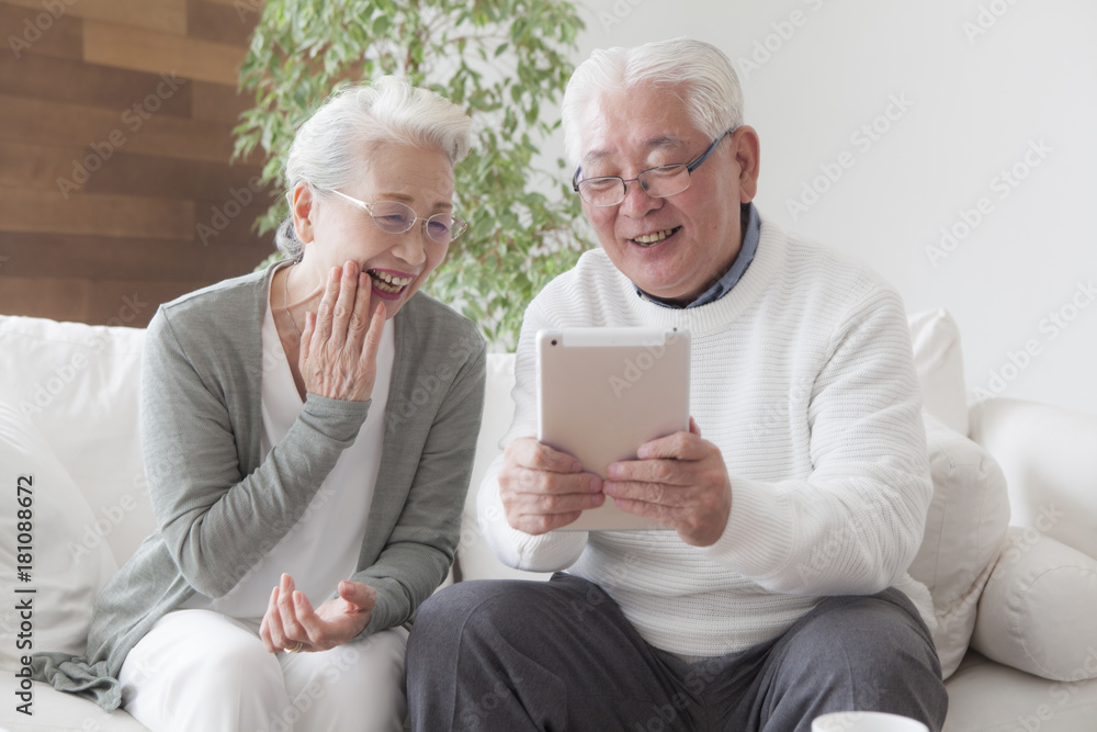 An old couple enjoying tablets An old couple enjoying tablets