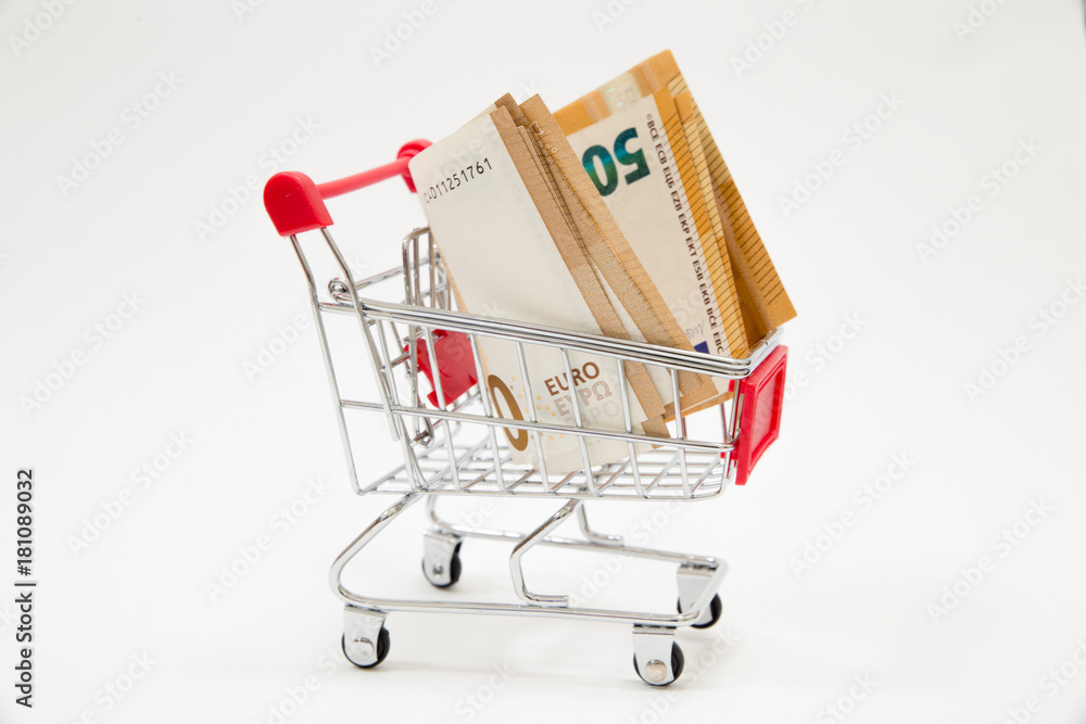 Shopping cart full of money (euro) isolated on white. Shopping spree, business, finance, economy concept