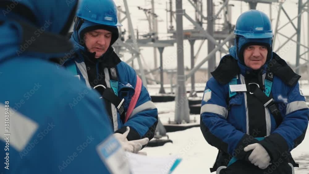 Worker puts on gloves standing on the street Worker puts on gloves standing on the street