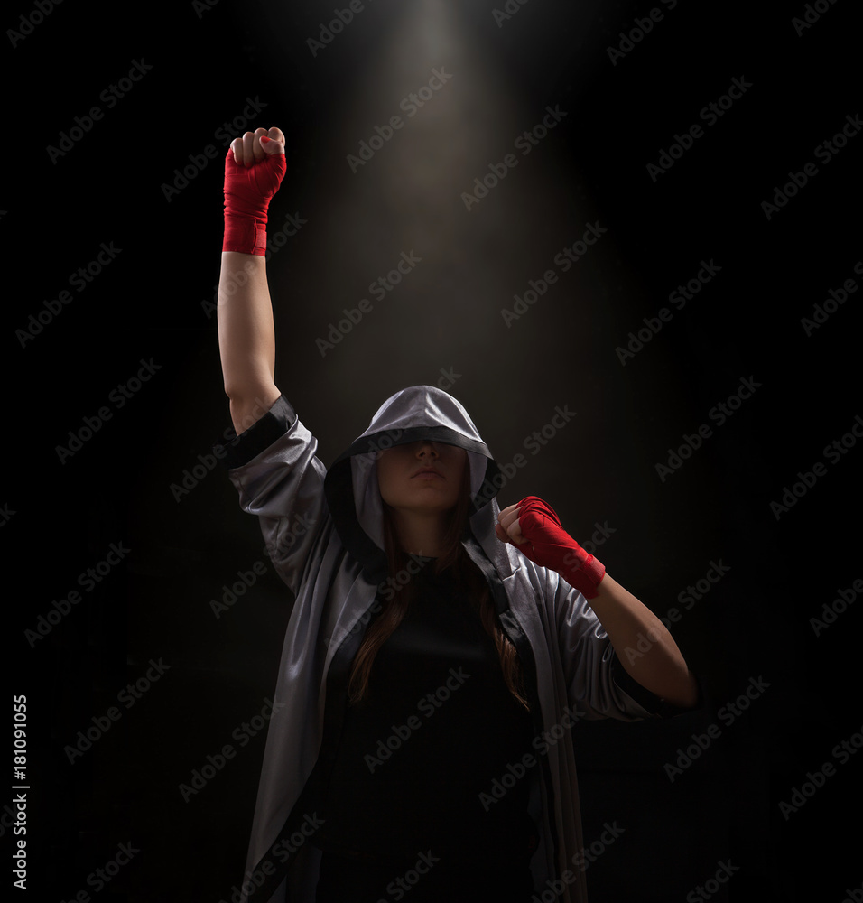 Foto Stock Female boxer with red boxing wraps wins the fight and bacame a  champion. Victory pose. Black background with copy space. | Adobe Stock