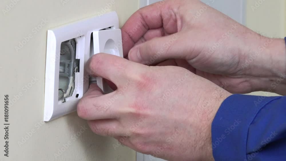 Electrician worker hands install electrical wall sockets Electrician worker hands install electrical wall sockets