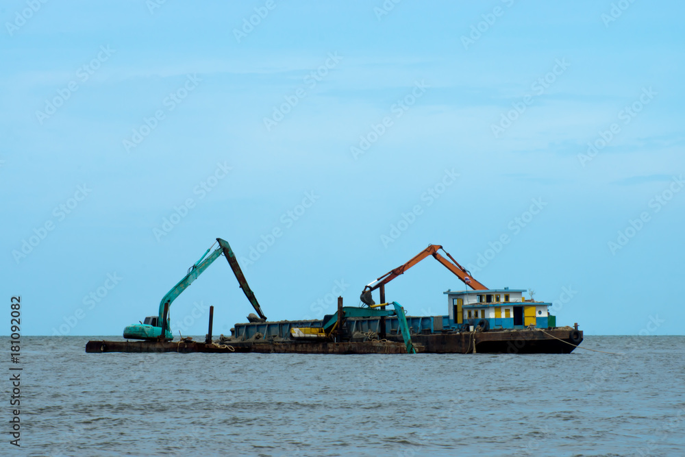 Machines are dredging sand in the sea. Machines are dredging sand in the sea.