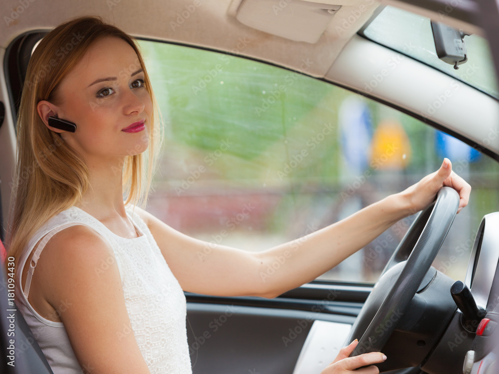 woman driving car with headset woman driving car with headset