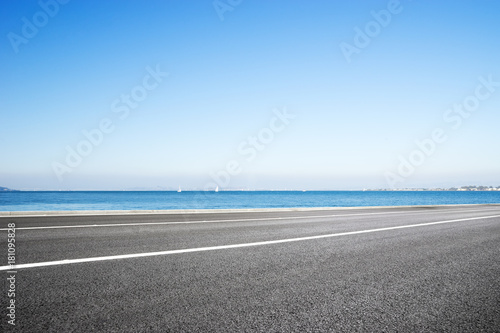 Fototapeta Naklejka Na Ścianę i Meble -  empty asphalt road with blue sea in blue sky