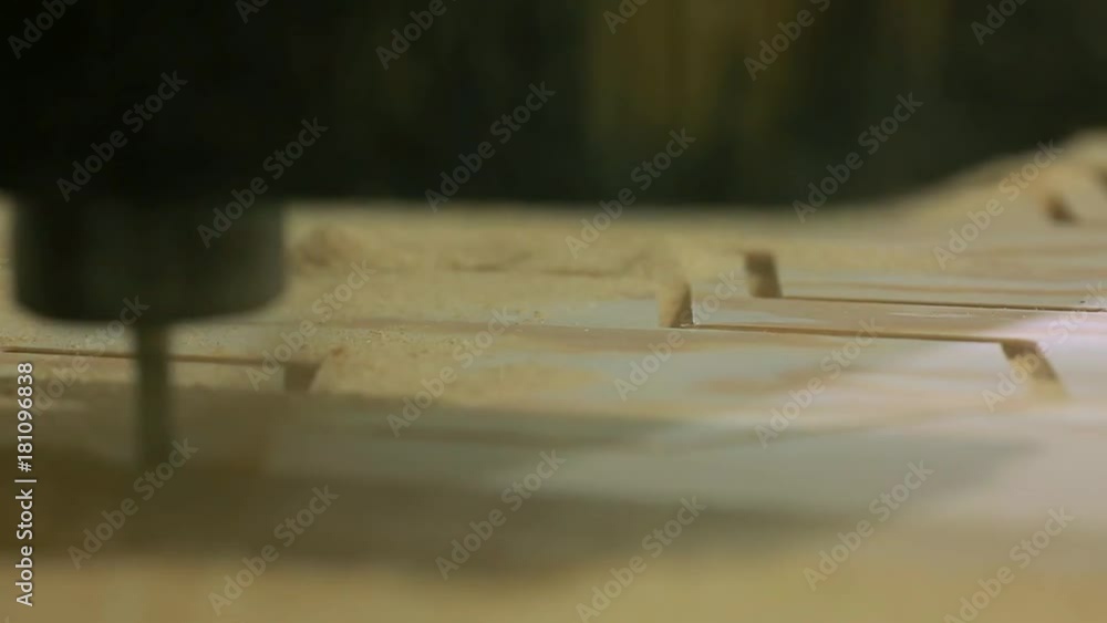 Close-up, milling machine automatically moves on the surface of the wood and independently performs the manufacture of parquet boards. Close-up, milling machine automatically moves on the surface of the wood and independently performs the manufacture of parquet boards.