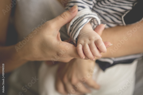 Newborn baby lying in her mother's arms