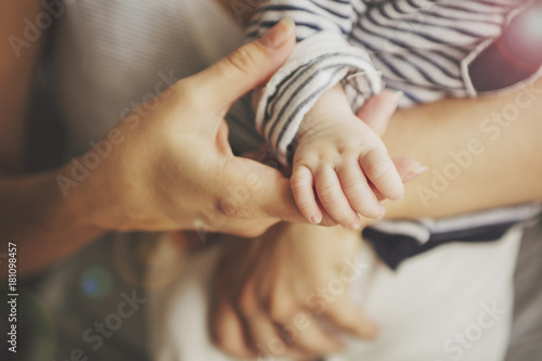 Newborn baby lying in her mother's arms