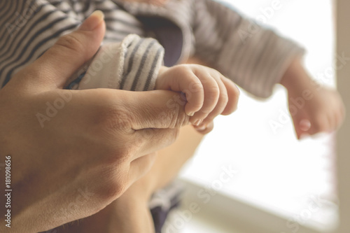 Fototapeta Naklejka Na Ścianę i Meble -  Newborn baby lying in her mother's arms
