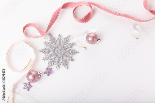 Christmas holiday composition. Festive creative gold silver pattern, xmas pink decor holiday ball with ribbon, snowflakes on white background. Flat lay, top view