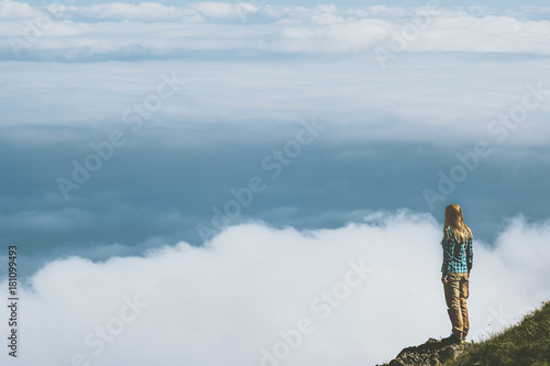 Fototapeta Naklejka Na Ścianę i Meble -  Woman standing on cliff above clouds mountains Travel Lifestyle adventure emotional concept  vacations outdoor