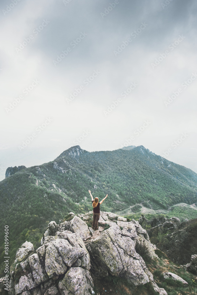 Happy traveler standing on mountain summit hands raised Travel Lifestyle success motivation concept adventure active vacations outdoor aerial foggy landscape on background