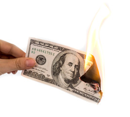a hundred dollars burn in a fire on a white background