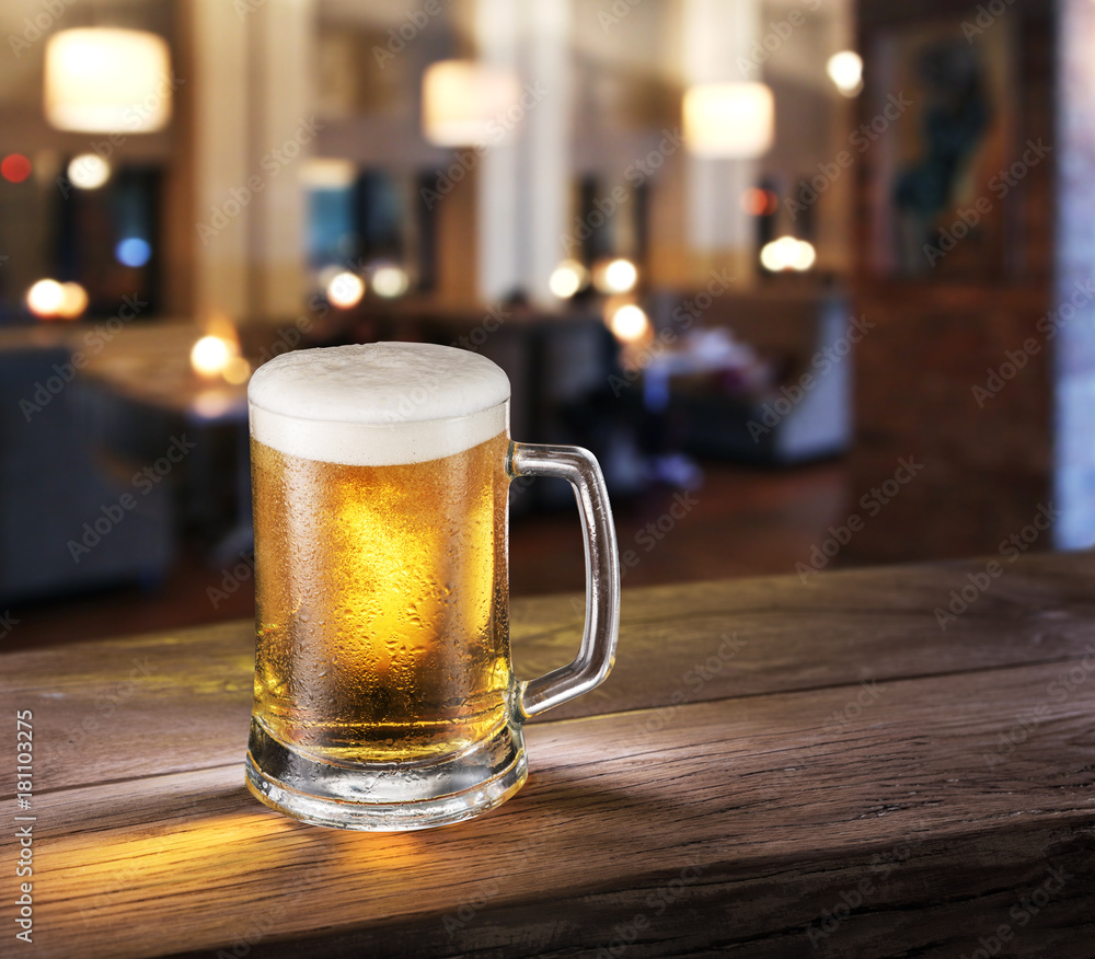 Frosty glass of light beer on the bar counter. Frosty glass of light beer on the bar counter.
