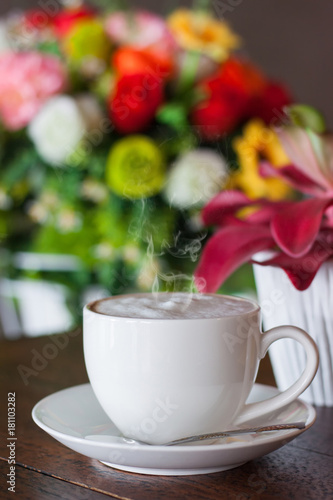 Hot coffee in a white cup in a coffee shop