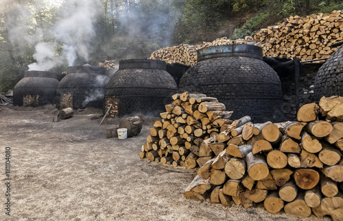 Fototapeta Naklejka Na Ścianę i Meble -  The production of charcoal in a traditional manner in the forest