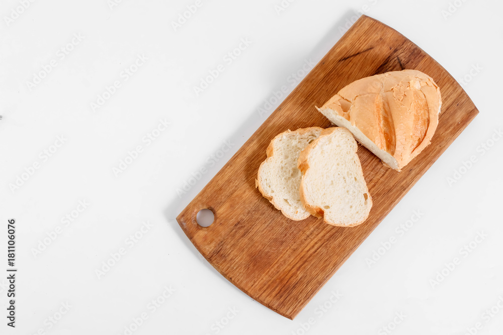 Top view of slices of white bread on a kitchen board, on a white background.