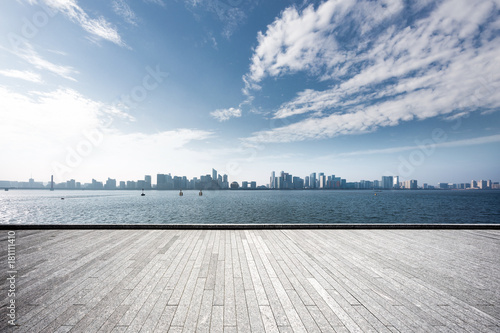 empty brick floor with modern cityscape