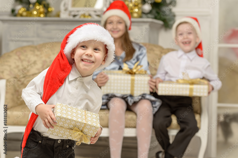 Smiling little boy holds Christmas gift Smiling little boy holds Christmas gift
