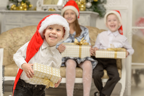 Smiling little boy holds Christmas gift