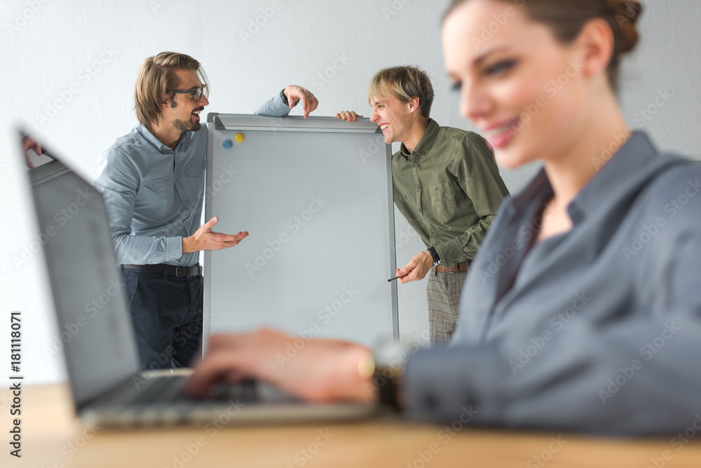 Businessmen laughing at flipchart Businessmen laughing at flipchart