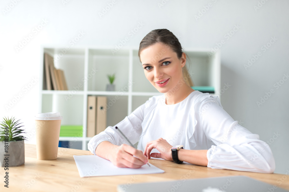 happy businesswoman sitting at table happy businesswoman sitting at table