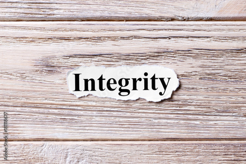 Integrity of the word on paper. concept. Words of Integrity on a wooden background photo