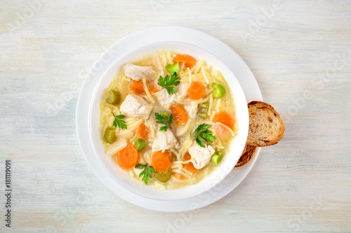Chicken soup with noodles, overhead photo with copyspace