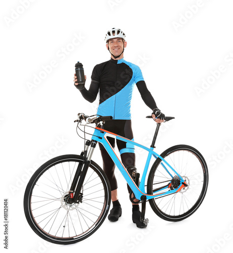 Young sporty cyclist with bicycle and beverage on white background