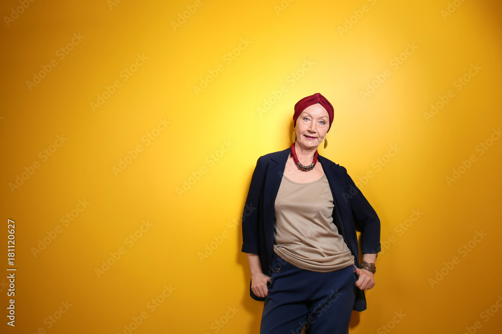 Attractive mature woman on yellow background Attractive mature woman on yellow background