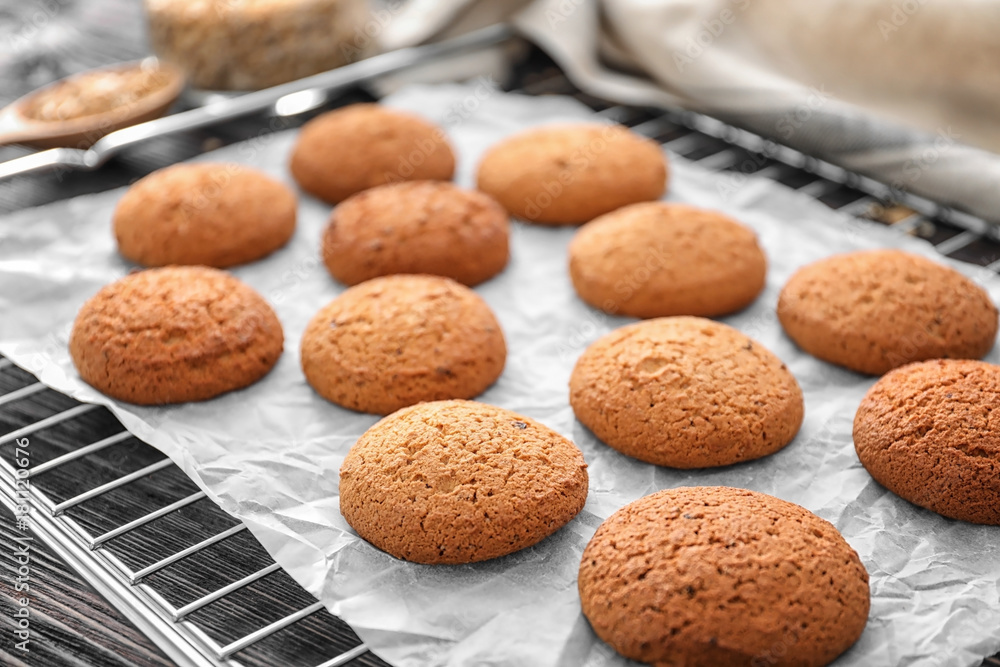 Cooling rack with delicious oatmeal cookies on table, closeup Cooling rack with delicious oatmeal cookies on table, closeup