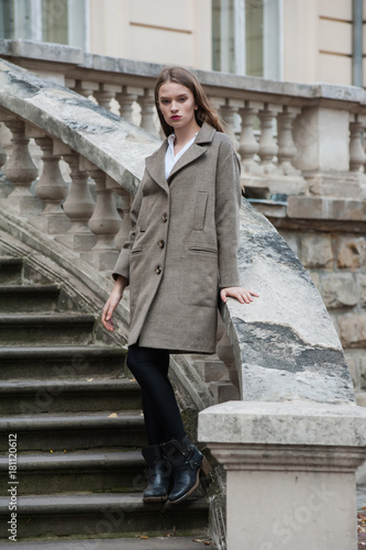 Beautiful young woman posing on the stairs