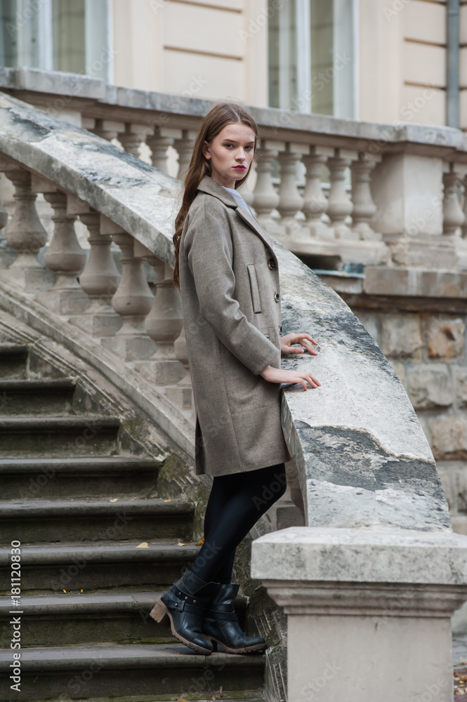 Beautiful young woman posing on the stairs Beautiful young woman posing on the stairs